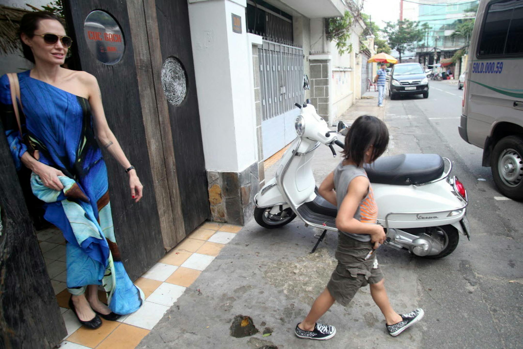American actress Angelina Jolie, left, and her adopted son Pax Thien leave a Vietnamese restaurant in Ho Chi Minh City, Vietnam, after lunch in November 2011. At the time, Hollywood power couple Jolie and Brad Pitt and their six children were on a visit to Vietnam, where Pax was born.