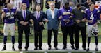 Minnesota Vikings general manager Rick Spielman, owners Mark Wilf and Zygi Wilf stood with players Harrison Smith (22) (left) during the National Anth