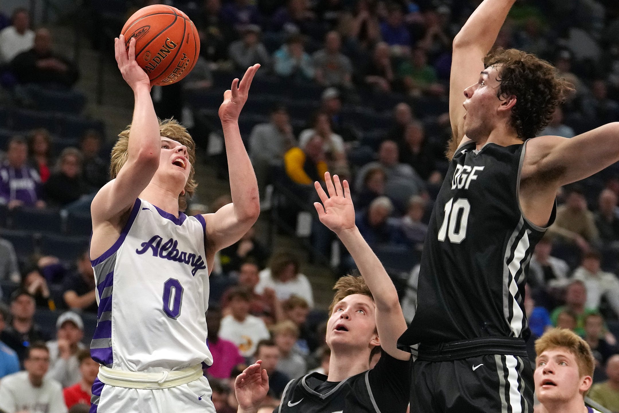 Albany guard Zeke Austin (0) goes up for a shot under pressure from DGF guard Owen Leach (10) in the first half.