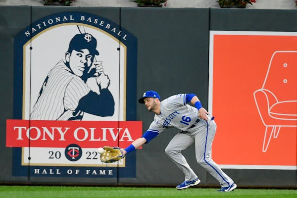Kansas City Royals left fielder Andrew Benintendi catches a line drive hit by Minnesota Twins' Byron Buxton during the seventh inning of a baseball ga
