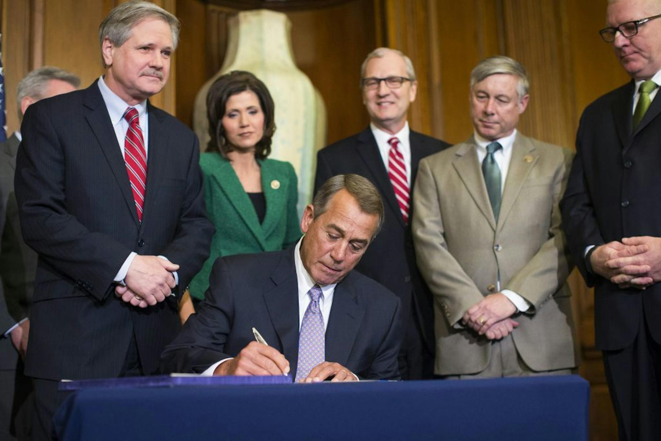 House Speaker John Boehner (R-Ohio) signs the Keystone XL Pipeline bill during a ceremony on Capitol Hill in Washington, Feb. 13, 2015. The bill will be sent to President Barack Obama, who has promised to veto it and has 10 days to do so.