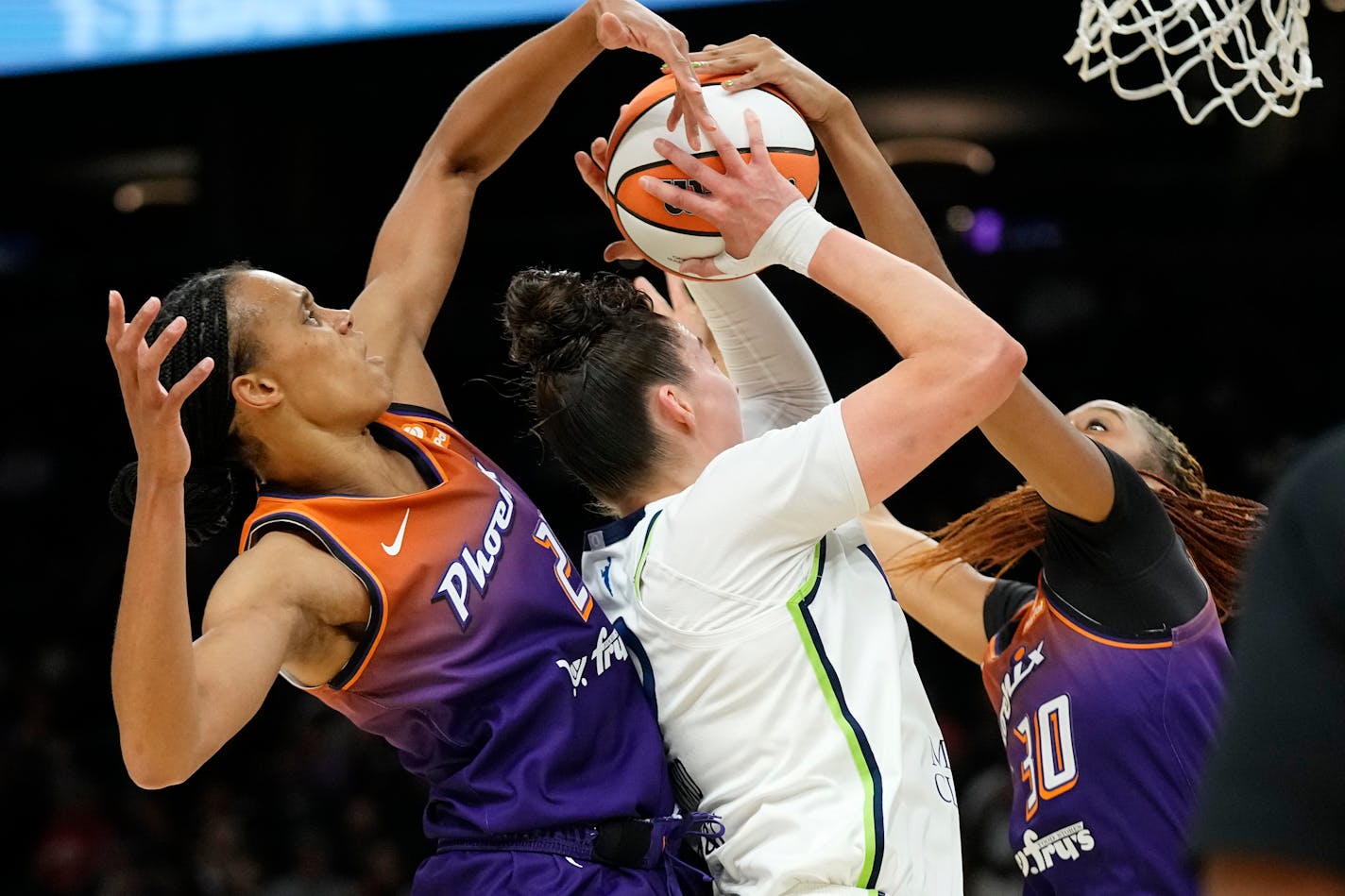 Phoenix Mercury forward Brianna Turner, left, and forward Kadi Sissoko (30) defend against Minnesota Lynx forward Jessica Shepard, middle, during the first half of a WNBA basketball game Thursday, May 25, 2023, in Phoenix. (AP Photo/Ross D. Franklin)