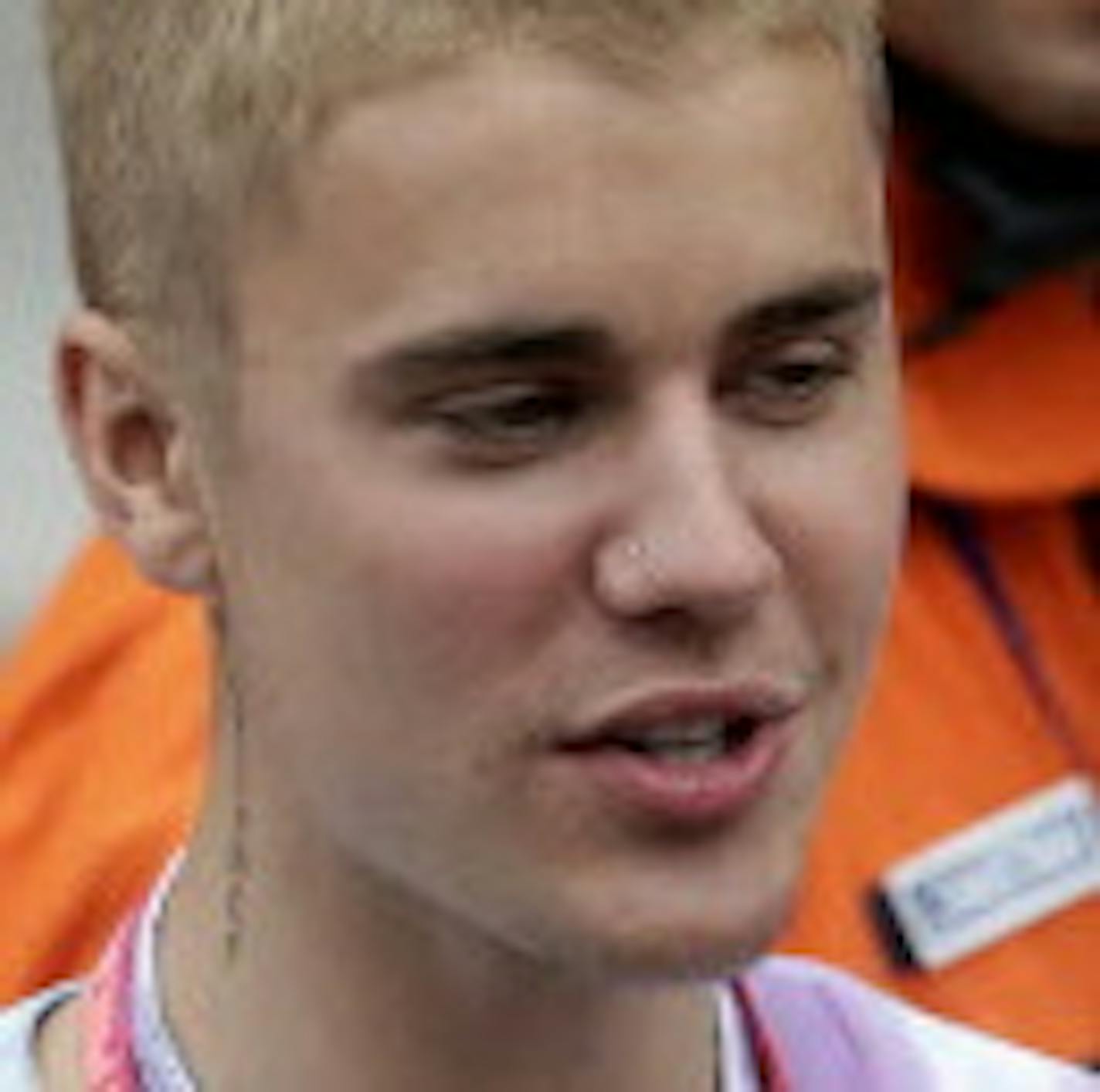 Mercedes driver Lewis Hamilton of Britain talks with Justin Bieber, left, after winning the Monaco Formula One Grand Prix in Monaco, Sunday, May 29, 2016. (AP Photo/Petr David Josek)