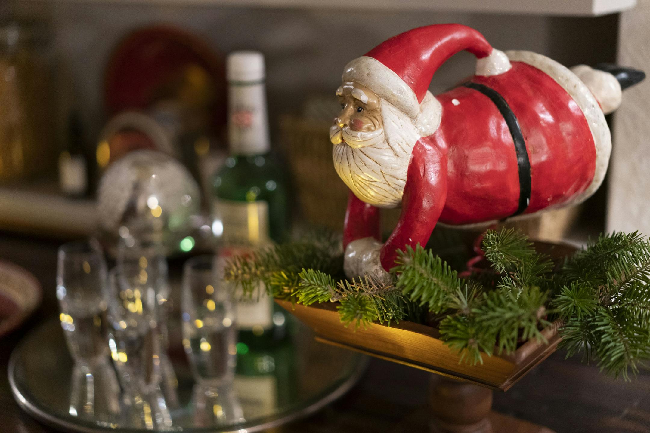 In designer Liz Knutson's home, a Santa figure watches over the basement bar.