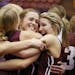 Jill Klaphake, center, and Kelsey Peschel of Sauk Centre celebrate their win with teammates over Norwood-Young America.