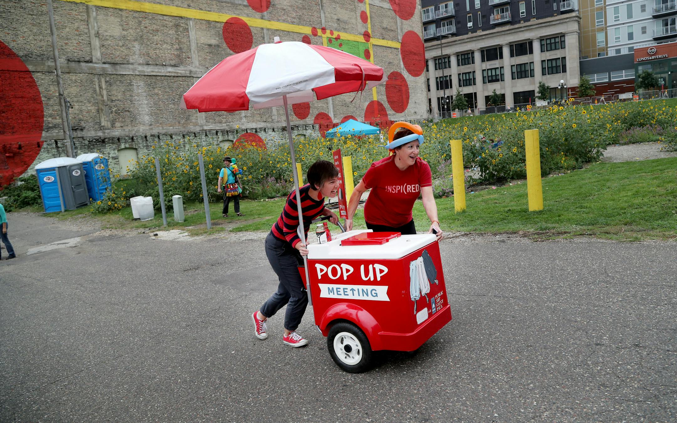 Pop Up Meeting truck, the two-year-old program and the brainchild of City Artist Amanda Lovelee, will be at its last event -- the year-end party for Urban Flower Field at Pedro Park Saturday, Sept. 24, 2016, in St. Paul, MN. Here, Lovelee, left, gets a hand pushing the Pop Up popsicle cart from Colleen Sheehy, president and executive director at Public Art Saint Paul.](DAVID JOLES/STARTRIBUNE)djoles@startribune.com Pop Up Meeting truck and staff will be at the Year End Party for the Urban Flower