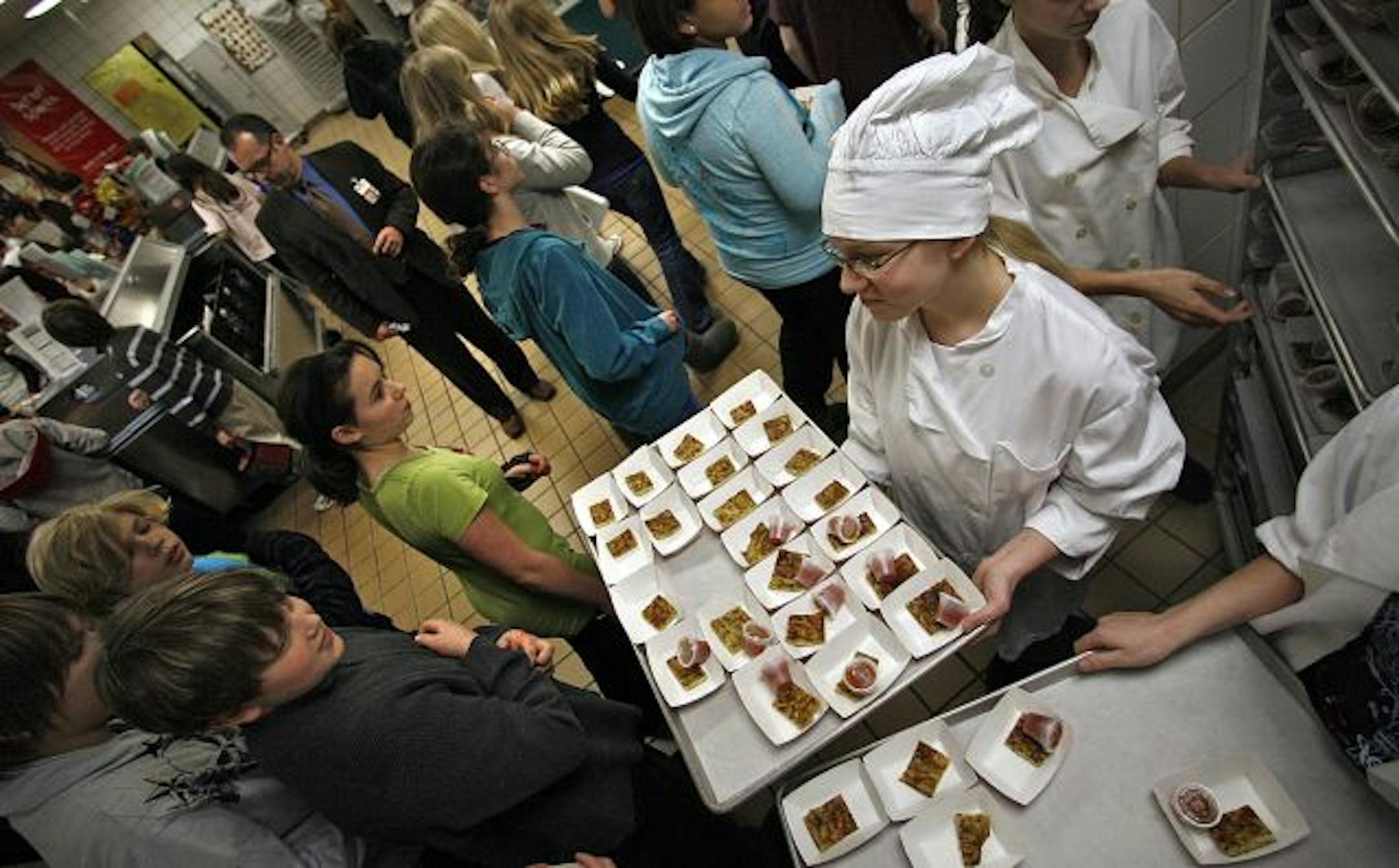 Try it, you'll like it: Student chef Sarah Youngner , 13, offered her classmates a taste of zucchini egg bake on Wednesday at teh Falcon Ridge Middle School in Apple Valley. Sarah and others were asked to cook up ways to make the vegetable attractive and tasty to her peers.