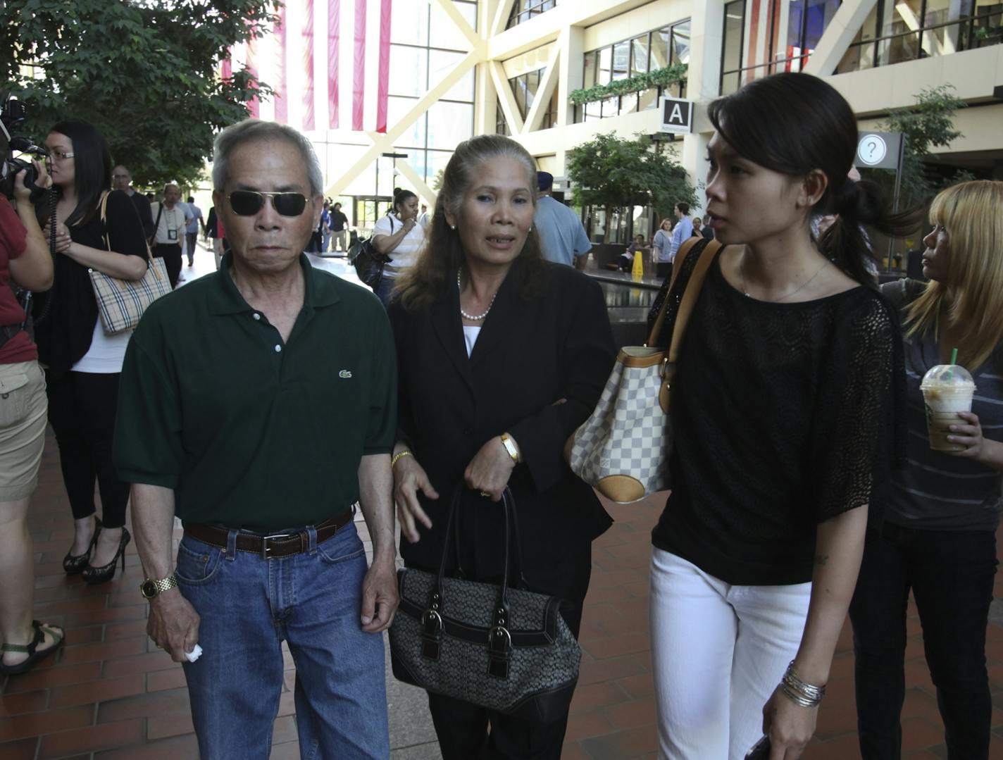 The parents of Anousone Phanthavong, including his father Phoxay, left, and mother, Keo, center, and niece Souksavahn, right, leave the Hennepin County Government Center after the verdict.