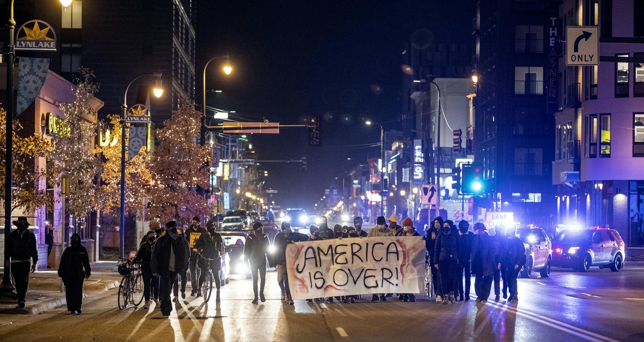 Small group marching on Lake St in the Uptown area a Minneapolis.
