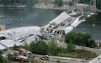 This view shows the Interstate 35W freeway bridge over the Mississippi River after it collapsed Wednesday, Aug. 1, 2007, in Minneapolis, as emergency 