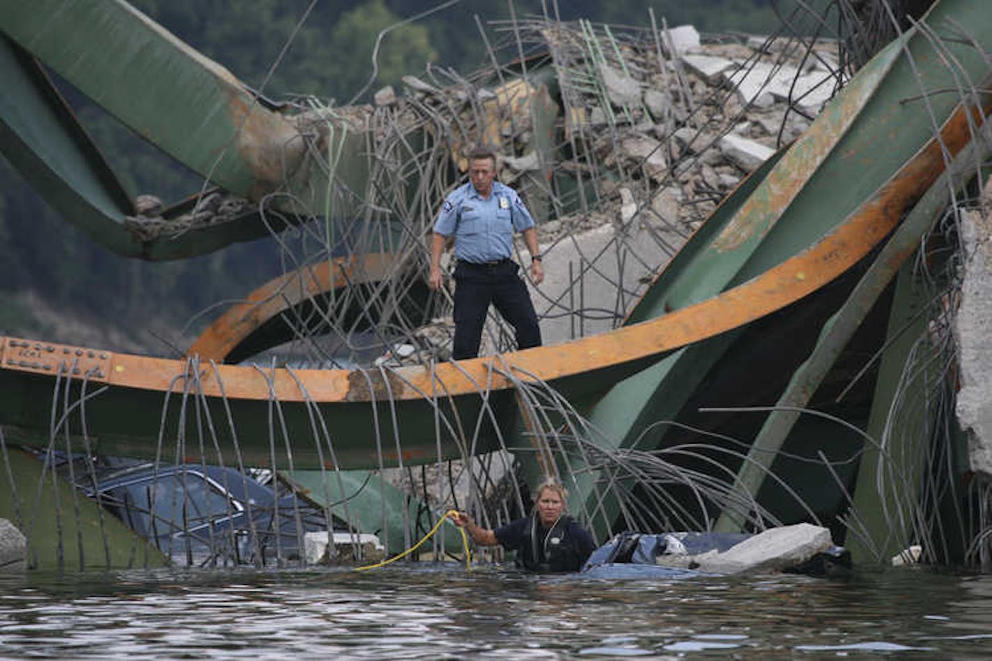 Rescue workers prepared to search a submerged vehicle