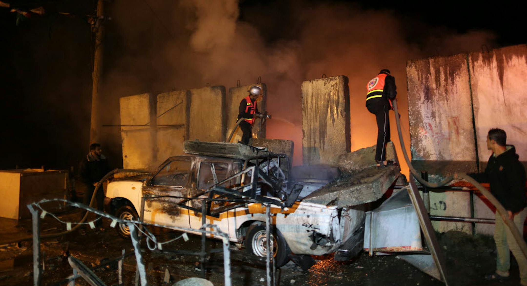 Firefighters work to put out a fire at a checkpoint near the home of Hamas's prime minister in Gaza, Ismail Haniya, following an Israeli airstrike Thursday.