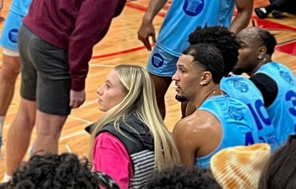 Paige Bueckers served as guest coach Monday and drew up plays for longtime friend and current NBA player Jalen Suggs, right.