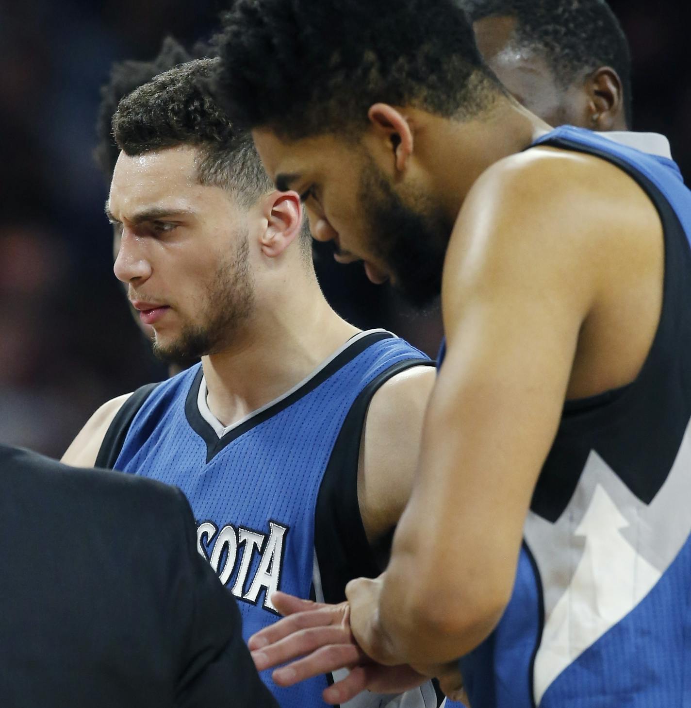 Minnesota Timberwolves guard Zach LaVine is helped off the court during the second half of the team's NBA basketball game against the Detroit Pistons, Friday, Feb. 3, 2017, in Auburn Hills, Mich. (AP Photo/Carlos Osorio)