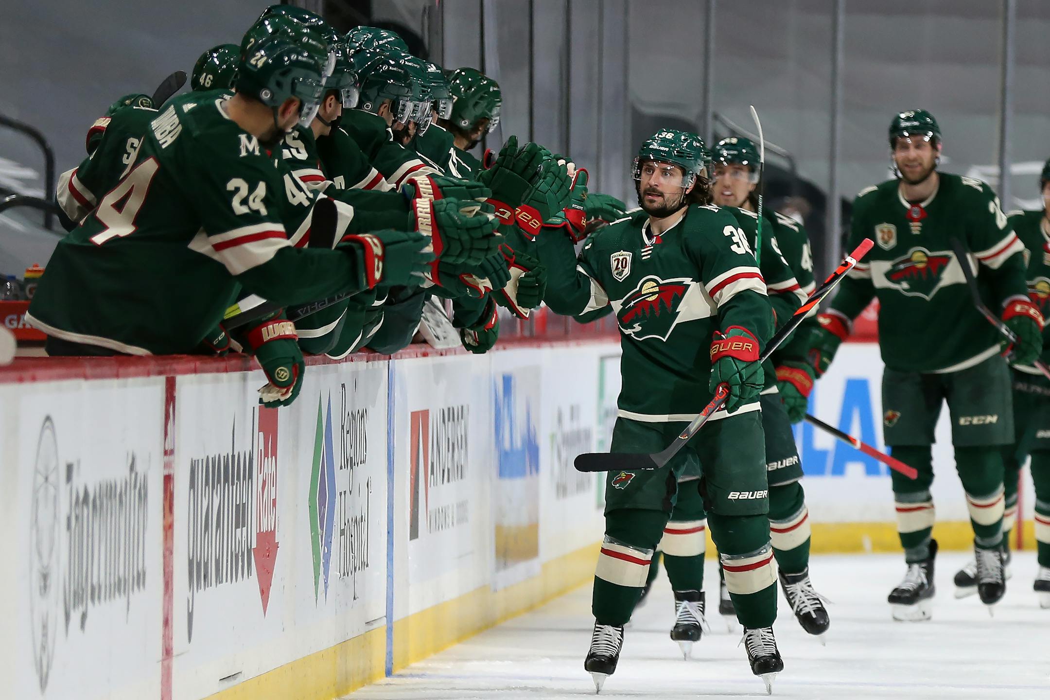 Wild's Mats Zuccarello high fives teammate on the bench in celebration after his goal against the San Jose Sharks