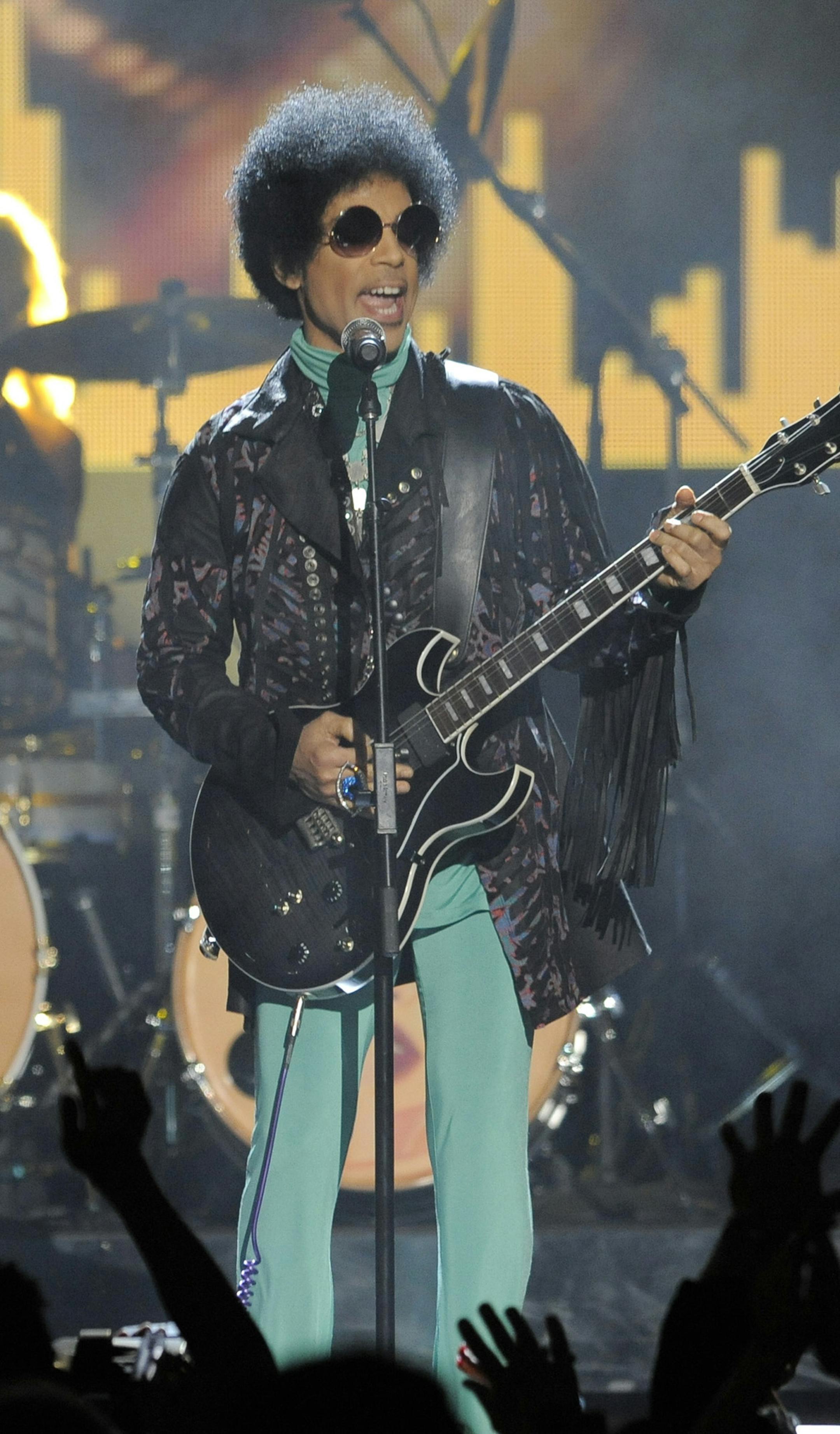 Prince performs at the Billboard Music Awards at the MGM Grand Garden Arena on Sunday, May 19, 2013 in Las Vegas. (Photo by Chris Pizzello/Invision/AP) ORG XMIT: MIN2013052917194842