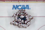 Boston College players huddle before the Frozen Four championship game against Denver.