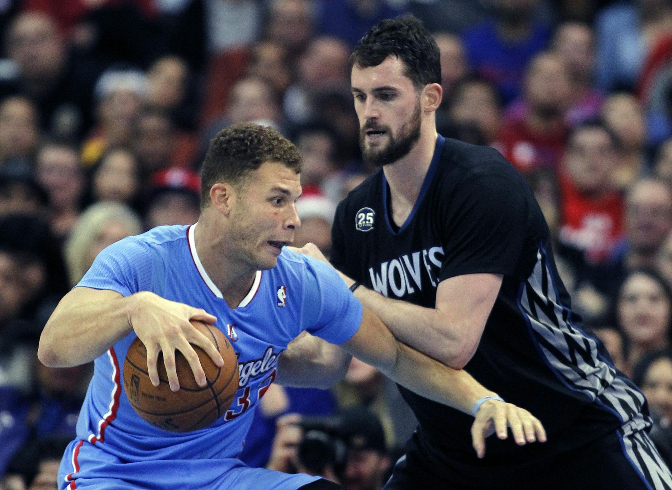 Los Angeles Clippers forward Blake Griffin (32) drives into Minnesota Timberwolves forward Kevin Love (42) in the second half of an NBA basketball game in Los Angeles on Sunday, Dec. 22, 2013. Clippers won the game 120-116 in overtime.