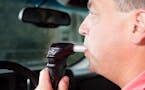 iStock
A male driver is blowing into an ignition interlock system which checks his alcohol concentration before allowing the vehicle to be started. Ig