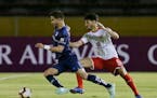 New Minnesota United striker Luis Amarilla, left, fights for the ball with Juan Sanchez Mino of Argentina's Independiente during a Copa Sudamericana m
