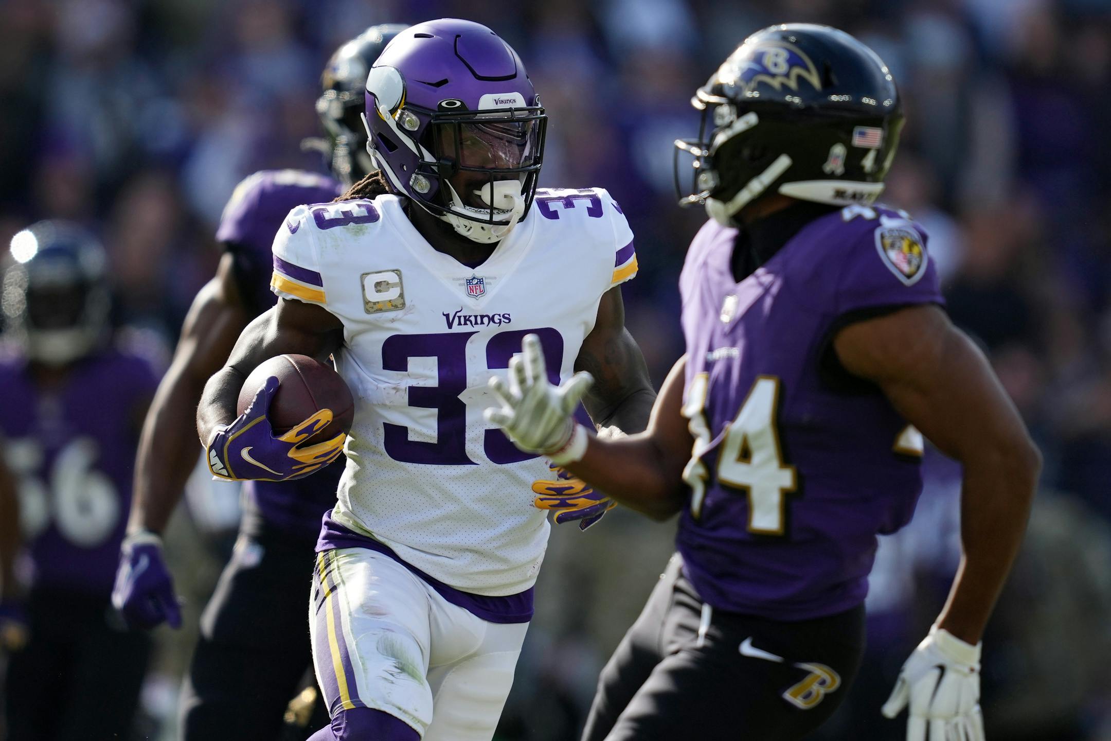 Vikings running back Dalvin Cook (33) rushed the ball around the Ravens defense in the first quarter of an NFL game between the Minnesota Vikings and the Baltimore Ravens.