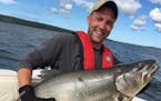 Nik Biebighauser of Minneapolis with a monster 45-pound lake trout he and his dad, Dave, caught in Lake Superior near Isle Royale National Park. They 