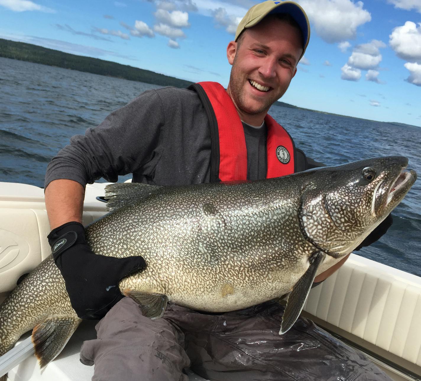 Nik Biebighauser of Minneapolis with a monster 45-pound lake trout he and his dad, Dave, caught in Lake Superior near Isle Royale National Park. They released it.