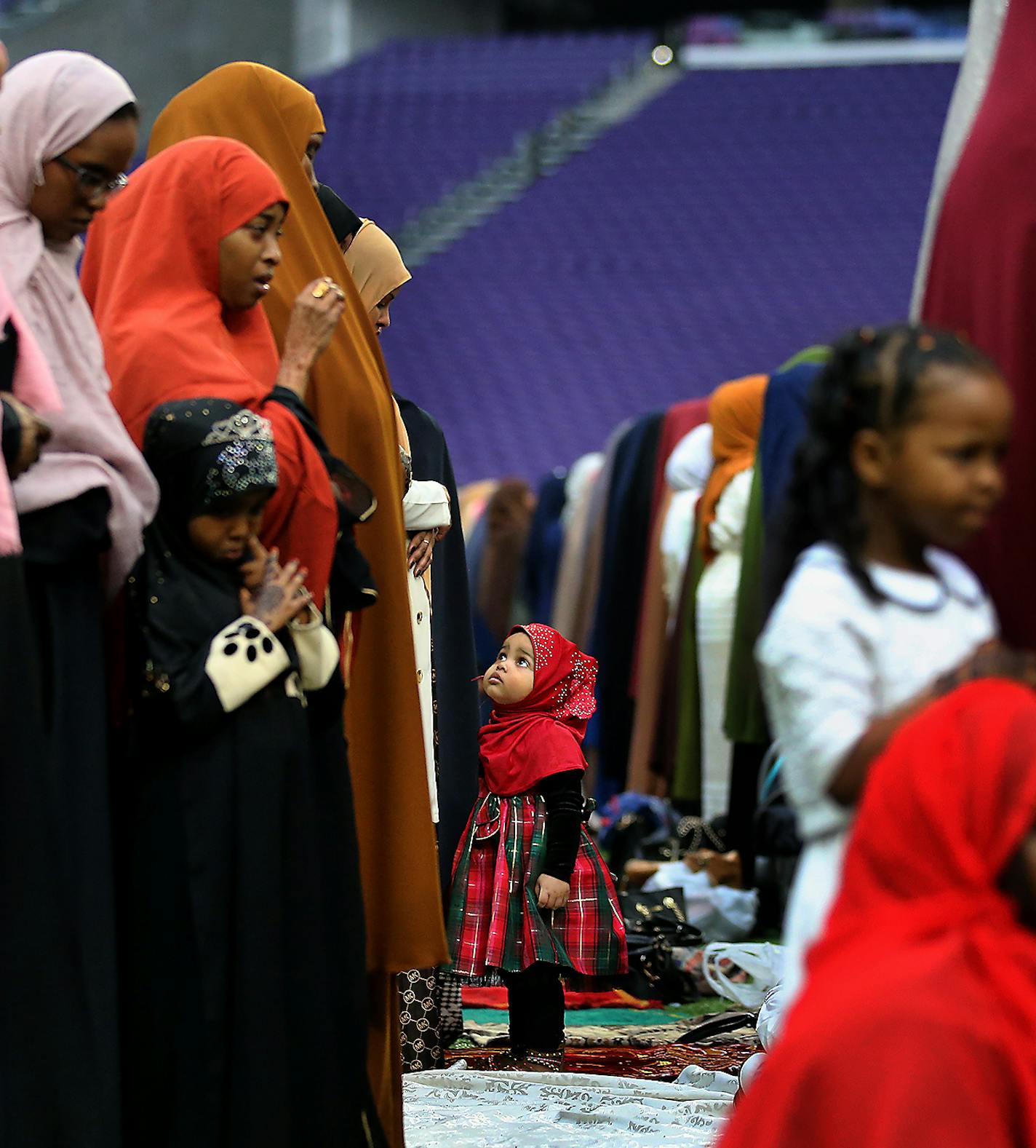 To celebrate Eid ul-Adha, the organization Super Eid hopes to bring together over 50,000 Muslims to pray. Here, a young Muslim worshiper looks up at her mother during prayers Tuesday, Aug. 21, 2018, at U.S. Bank Stadium, in Minneapolis, MN.] DAVID JOLES &#xef; david.joles@startribune.com To celebrate Eid ul-Adha, the organization Super Eid hopes to bring together over 50,000 Muslims to pray Tuesday at U.S. Bank Stadium. A celebration will follow at The Commons park adjacent to the stadium.**Abdu