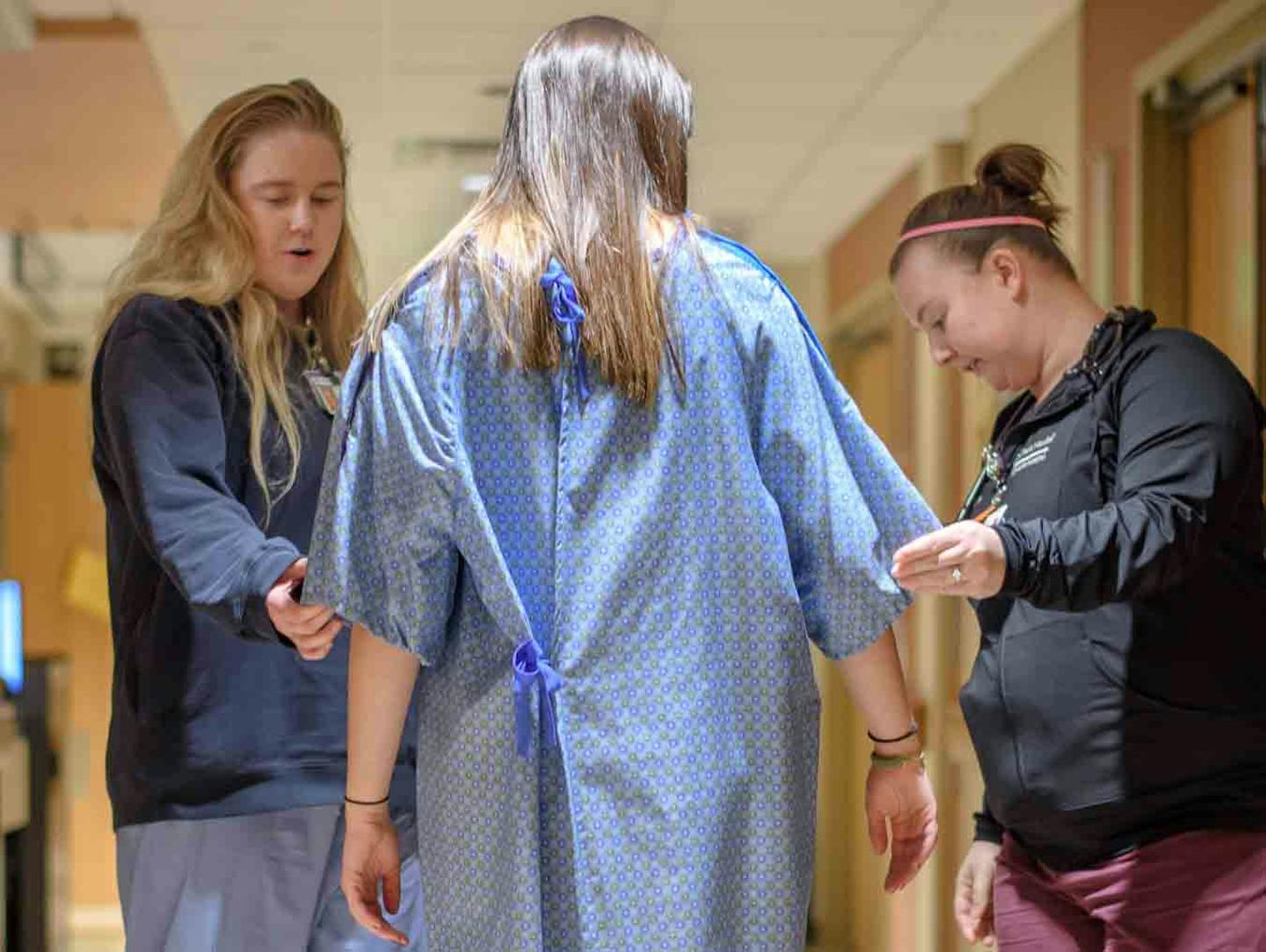 Nurses Katie Orsucci and Cat Hemp checked out one of the new gowns coming to Methodist Hospital. Along with higher-quality fabrics and sharper colors, the gowns offer less exposure for patients' backsides.