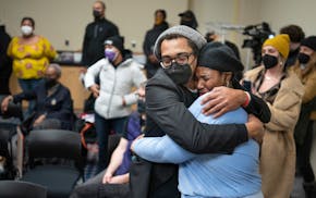Brock Sattter hugs Thandisizwe Jackson-Nisan during a gathering to honor Mel Reeves , in Minneapolis, Minn., on Tuesday, Jan. 11, 2022. Community memb