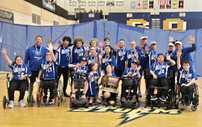 The Dakota United PI adapted softball team poses with its latest trophy Saturday at Chanhassen.