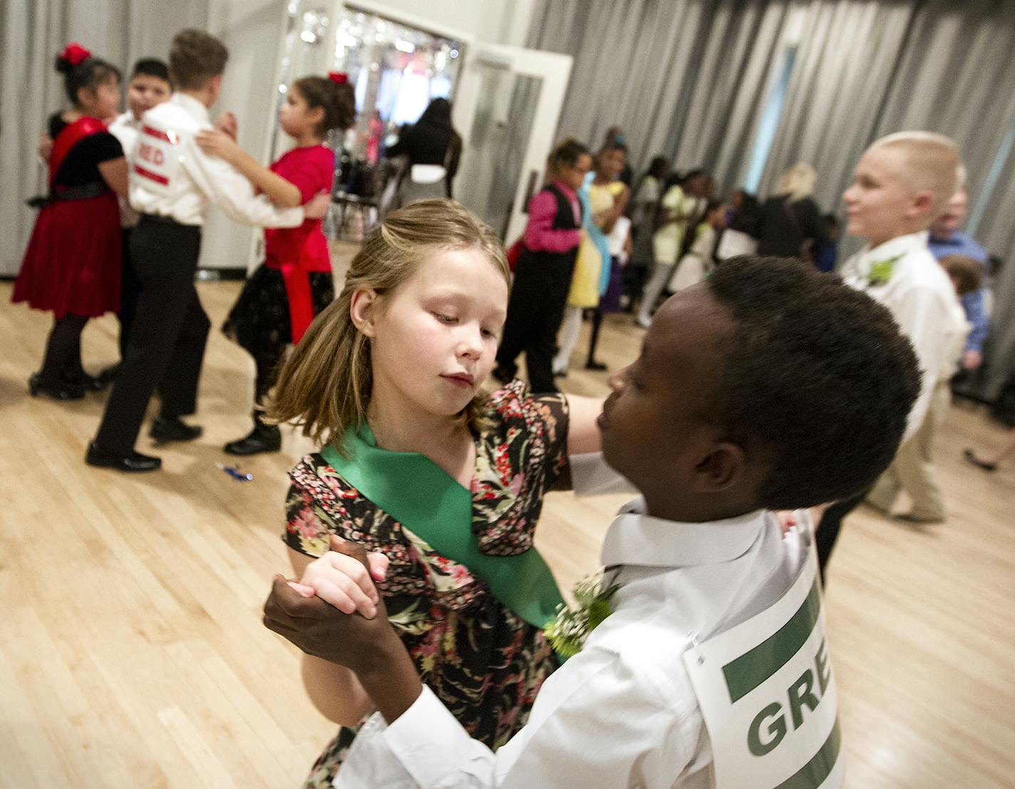 10-year-olds Dieudonnee Reponse, right, and Emilia Hulson practice the merengue before the Colors of the Rainbow Dancing Classrooms Team Match presented by Heart of Dance at Dancers Studio in St. Paul December 13, 2015. (Courtney Perry/Special to the Star Tribune)