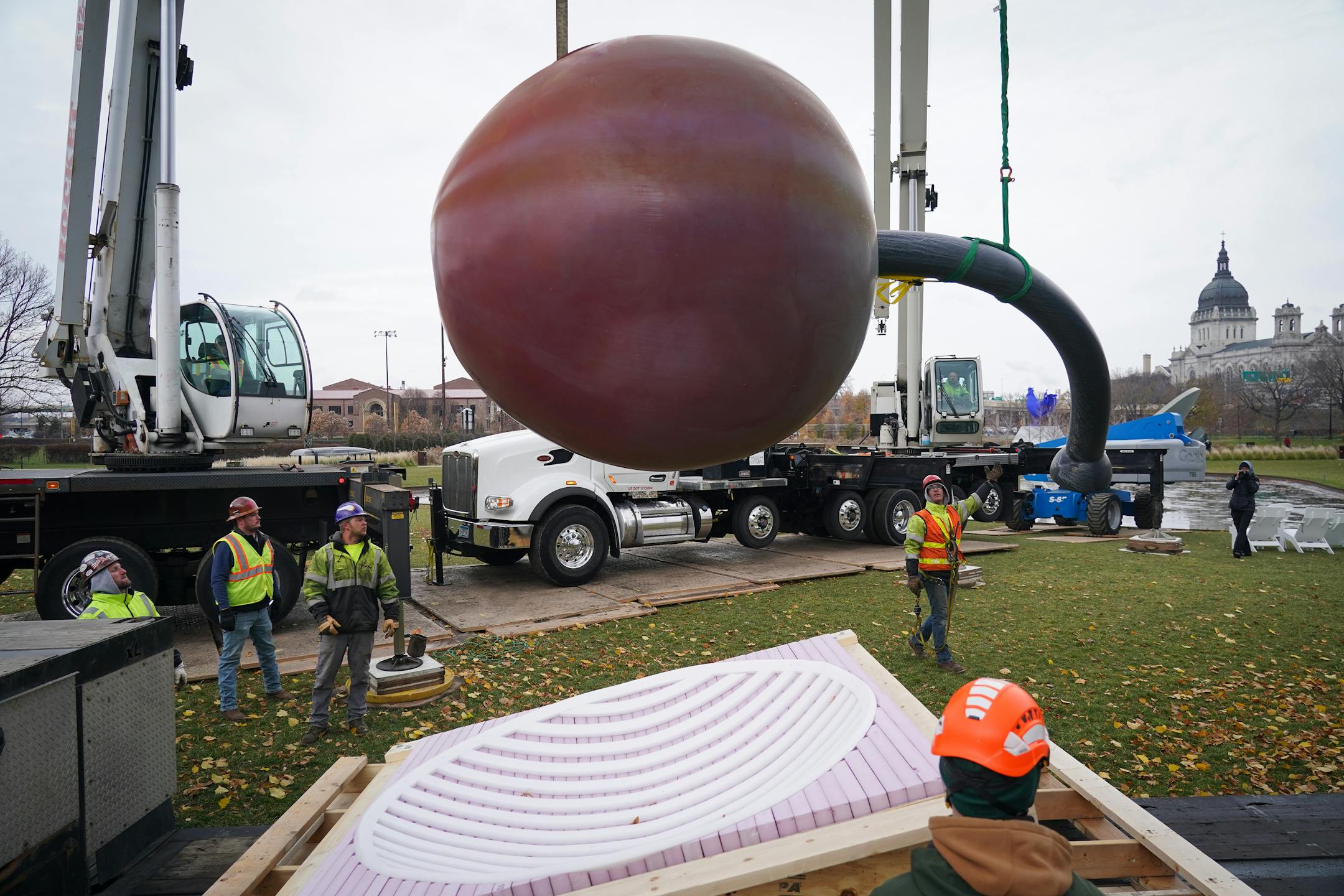 The 17500 pound aluminum cherry ball is unbolted, lifted, and separated from the Spoonbridge base it sits atop at the Sculpture Garden in Minneapolis, Minn., on Tuesday, Nov. 16, 2021. Due to the typically harsh conditions of Minnesota winters, this iconic Minneapolis fruit requires a fresh coat of paint about every ten years to keep the cherry's red crisp and glossy. ] SHARI L. GROSS • shari.gross@startribune.com