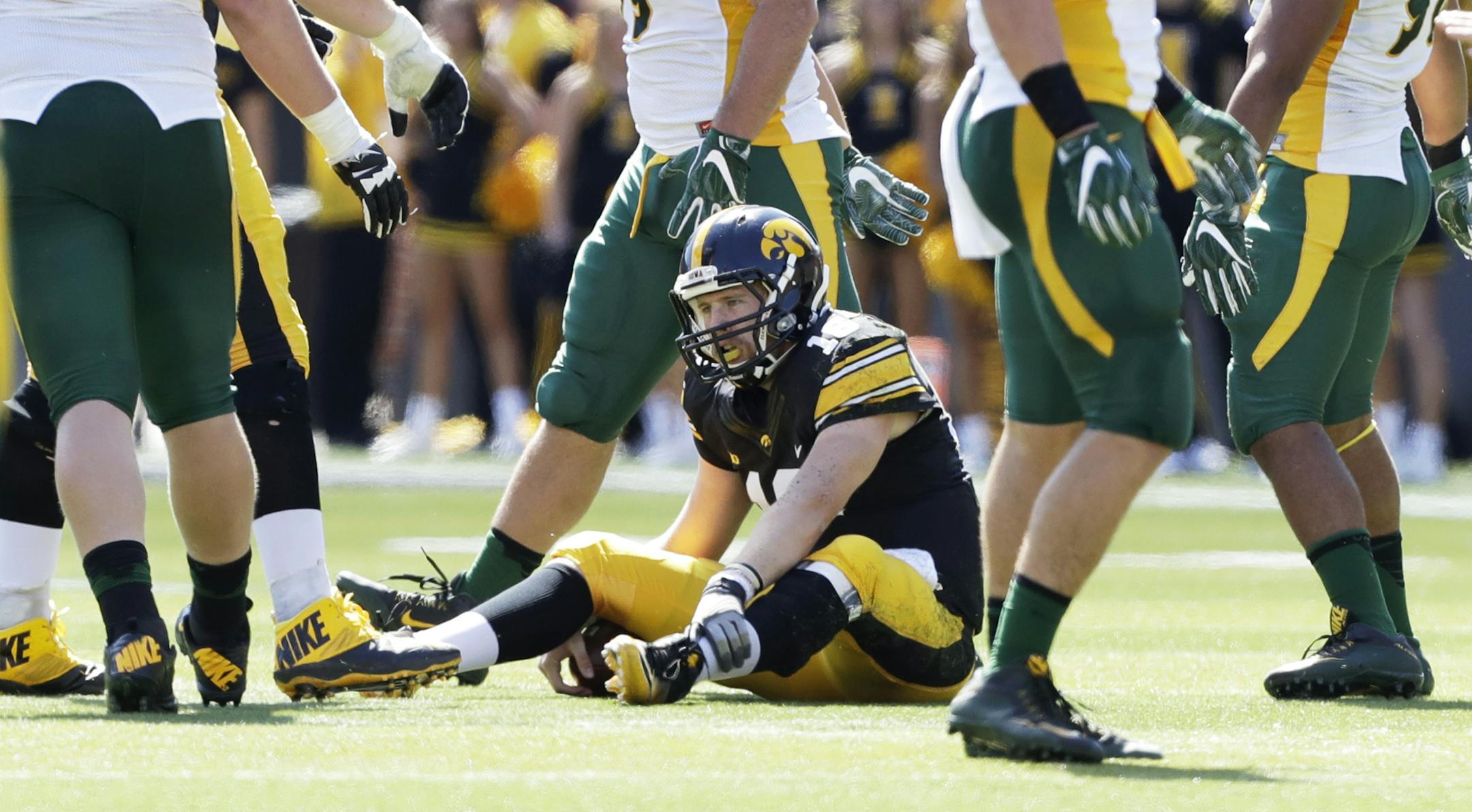 Iowa quarterback C.J. Beathard sits on the field after recovering a bad snap during the second half of an NCAA college football game against North Dakota State, Saturday, Sept. 17, 2016, in Iowa City, Iowa. North Dakota State won 23-21. (AP Photo/Charlie Neibergall) ORG XMIT: IACN111