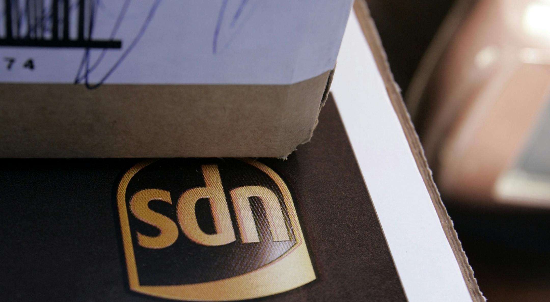 FILE - In this July 22, 2009 file photo, a United Parcel Service (UPS) package is shown in Palo Alto, Calif. UPS said Friday, Jan. 8, 2010, it will cut 1,800 management and administrative positions to streamline its U.S. package segment. (AP Photo/Paul Sakuma, file) ORG XMIT: MIN2013082119264304