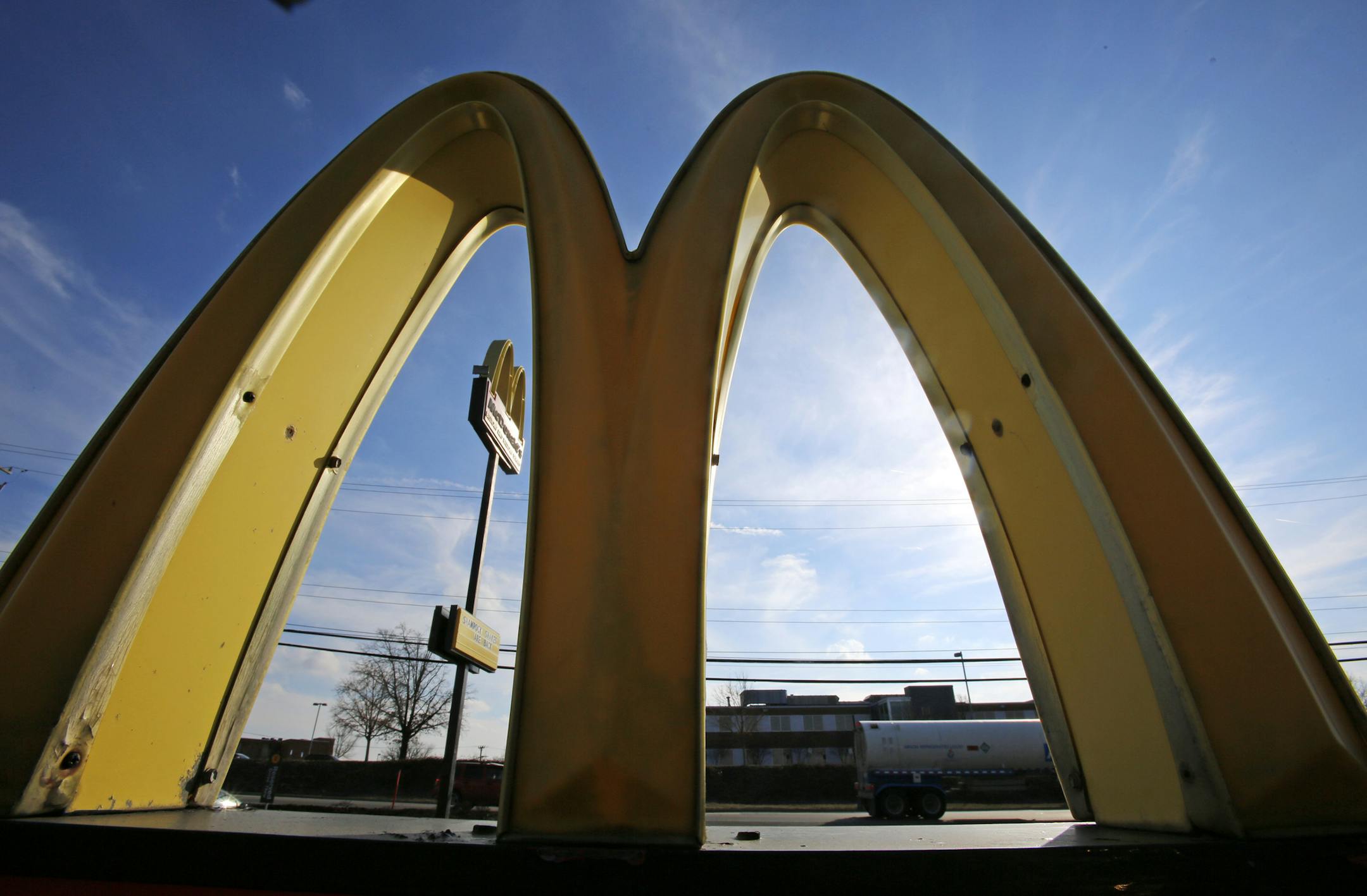 This Wednesday, Feb. 22, 2017, photo, shows the golden arches at sunset at a McDonald's restaurant in Robinson Township, Pa. McDonaldís Corp. says it will launch mobile order-and-pay and curbside pickup in the U.S. toward the end of 2017. (AP Photo/Gene J. Puskar) ORG XMIT: MIN2017041409302715