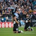 Minnesota United midfielder Jonathan Gonzalez (6) and teammate defender D.J. Taylor (27) dropped to their knees in thanks after the Loons won to advan