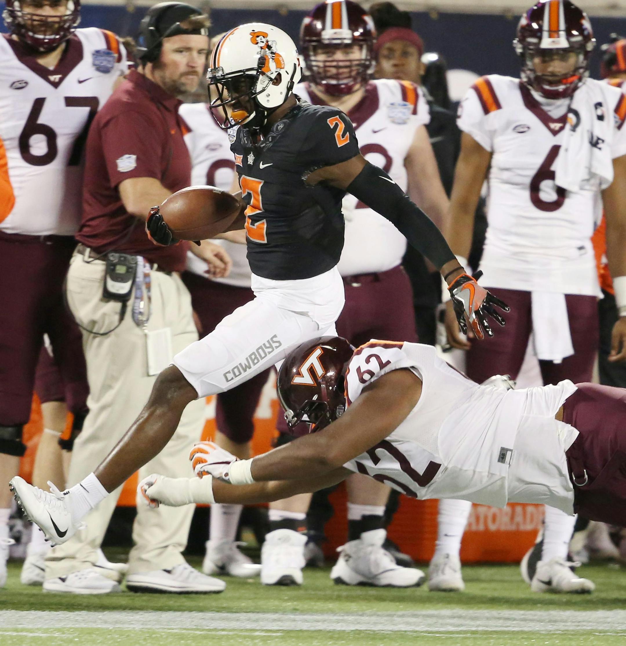 Oklahoma State safety Darius Curry (2) runs with an interception against Virginia Tech in the Camping World Bowl at Camping World Stadium in Orlando, Fla., on Thursday, Dec. 28, 2017. Oklahoma State won, 30-21. (Stephen M. Dowell/Orlando Sentinel/TNS)