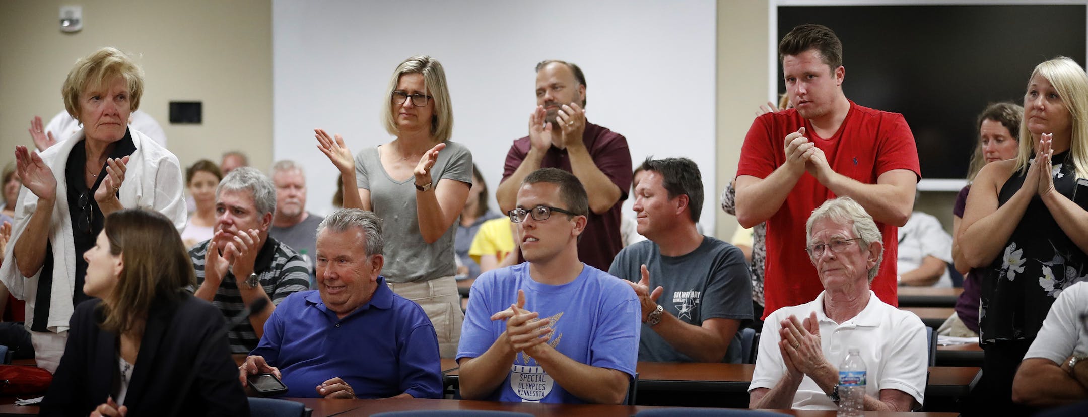 Some in attendance at the Prior Lake-Savage school board meeting reacted after school board member Melissa Enger was cleared after an investigation over allegation of underage drinking at her home. ] CARLOS GONZALEZ cgonzalez@startribune.com - June 27, 2016, Prior Lake, MN, The Prior Lake-Savage school board, still reeling from voters rejection of a $150 million referendum proposal on May 24, has hired a law firm to investigate allegations against school board member Melissa Enger, long known as