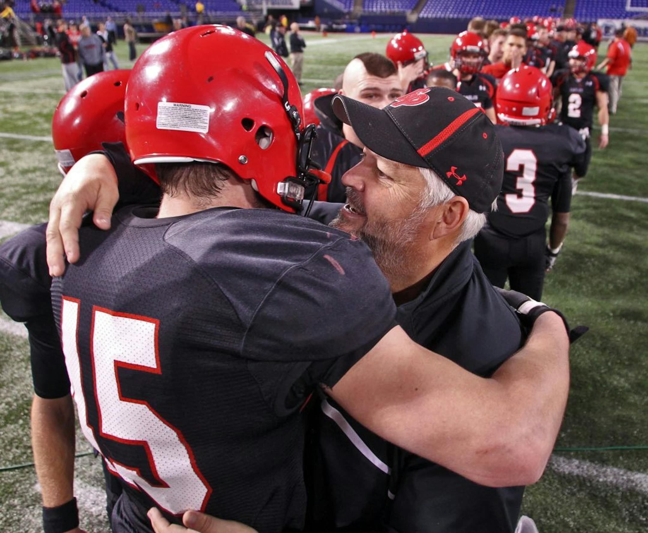 Head coach Mike Grant hugged Jack Cottrell. Cotrell had two interceptions in the Class 6A Prep Bowl.