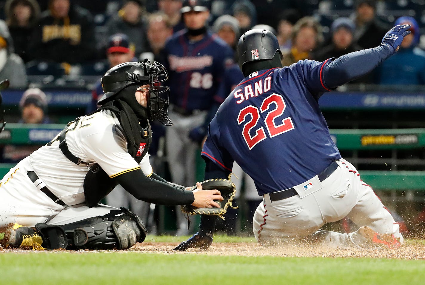 Minnesota Twins' Miguel Sano slides past the attempted tag by Pirates catcher Francisco Cervelli to score on a double by Logan Morrison on Wednesday.