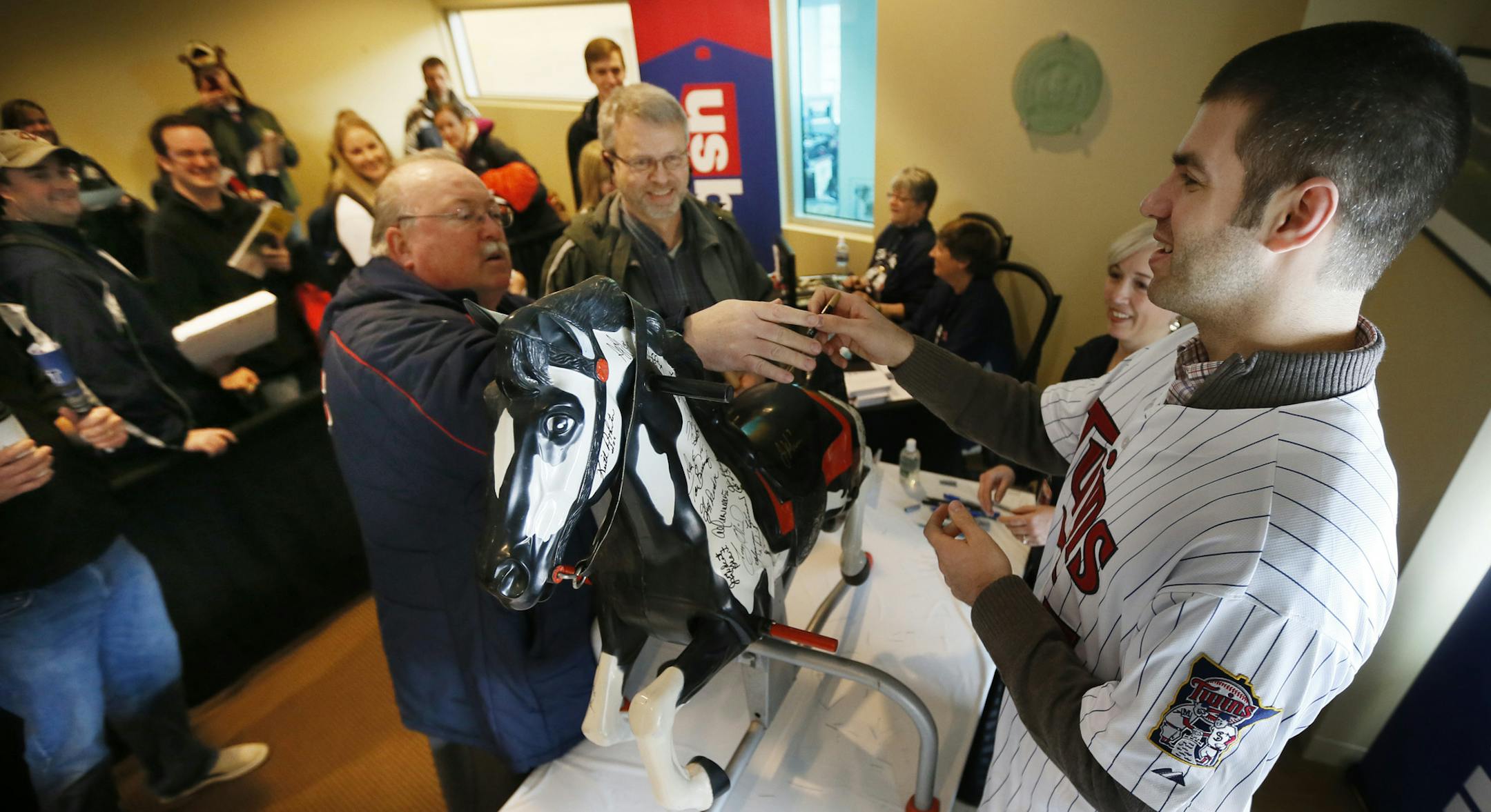 Jeff Thompson of Rochester got Joe Mauer to autograph “Blaze the wonder horse’’ during TwinsFest on Sunday. Thompson was given the horse in 1961 when he was 4 years old. Standing next to Thompson was his friend Alan Batzel.