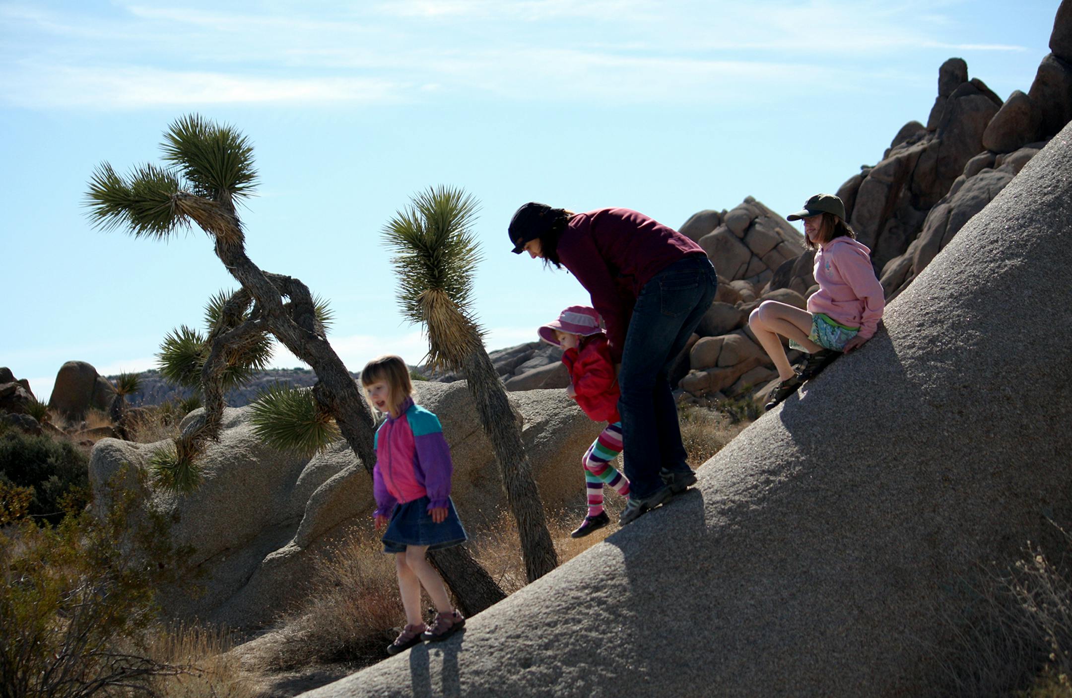 Laura Lundquist (from left), Beatrice Lundquist, Susan Stryk and Jane Lundquist explore the rock formations in Joshua Tree National Park, with the park&#x2019;s namesake tree (a form of yucca) as a backdrop.