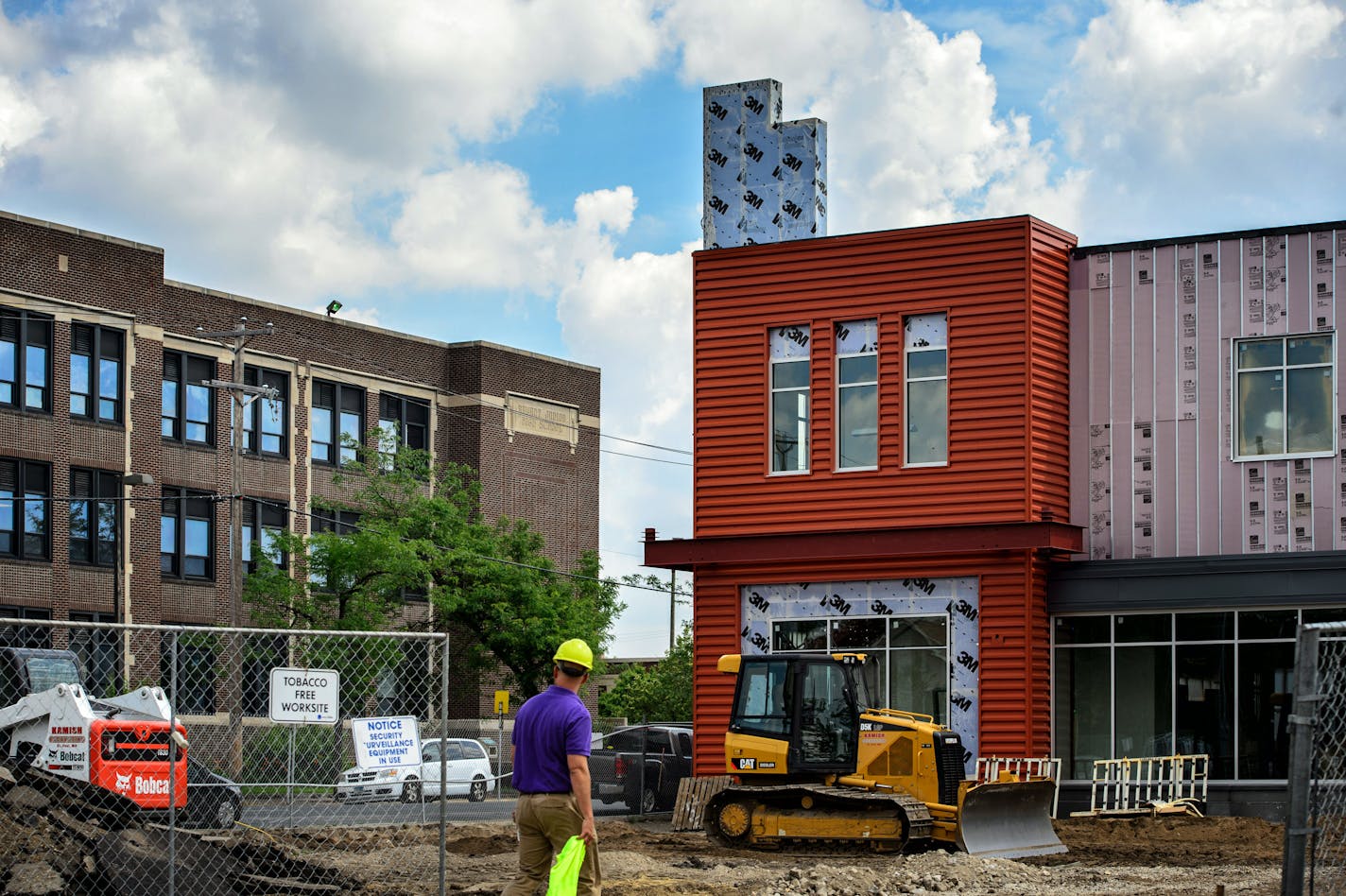 Sabathani Community Center, to the left, is housed in the former Bryant Junior High in south Minneapolis, which Prince attended. A new Seward Co-op market recently opened across the street.