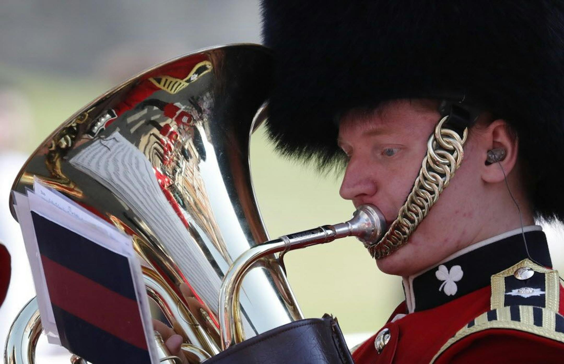 A military brass band player plays a tuba prior to the wedding ceremony of Prince Harry and Meghan Markle at St. George's Chapel in Windsor Castle in Windsor, near London, England, Saturday, May 19, 2018.