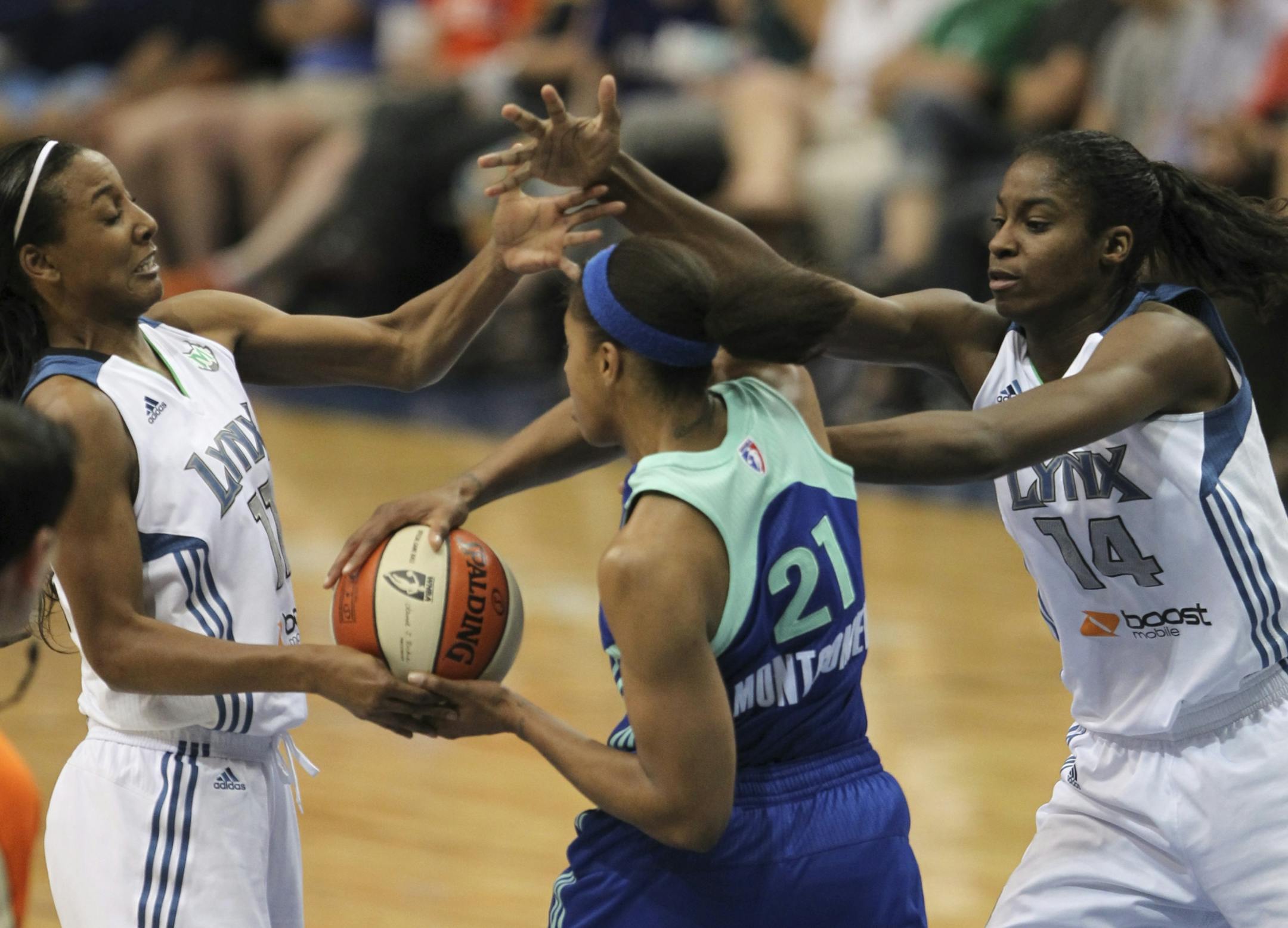 The Minnesota Lynx walloped the New York Liberty 102-70 in a WNBA game Thursday night, June 21, 2012 at Target Center in Minneapolis, Minn. Candice Wiggins, left, and Devereaux Peters of the Lynx tried to strip the ball from New York's Alex Montgomery after she grabbed a third quarter rebound under the Lynx net.