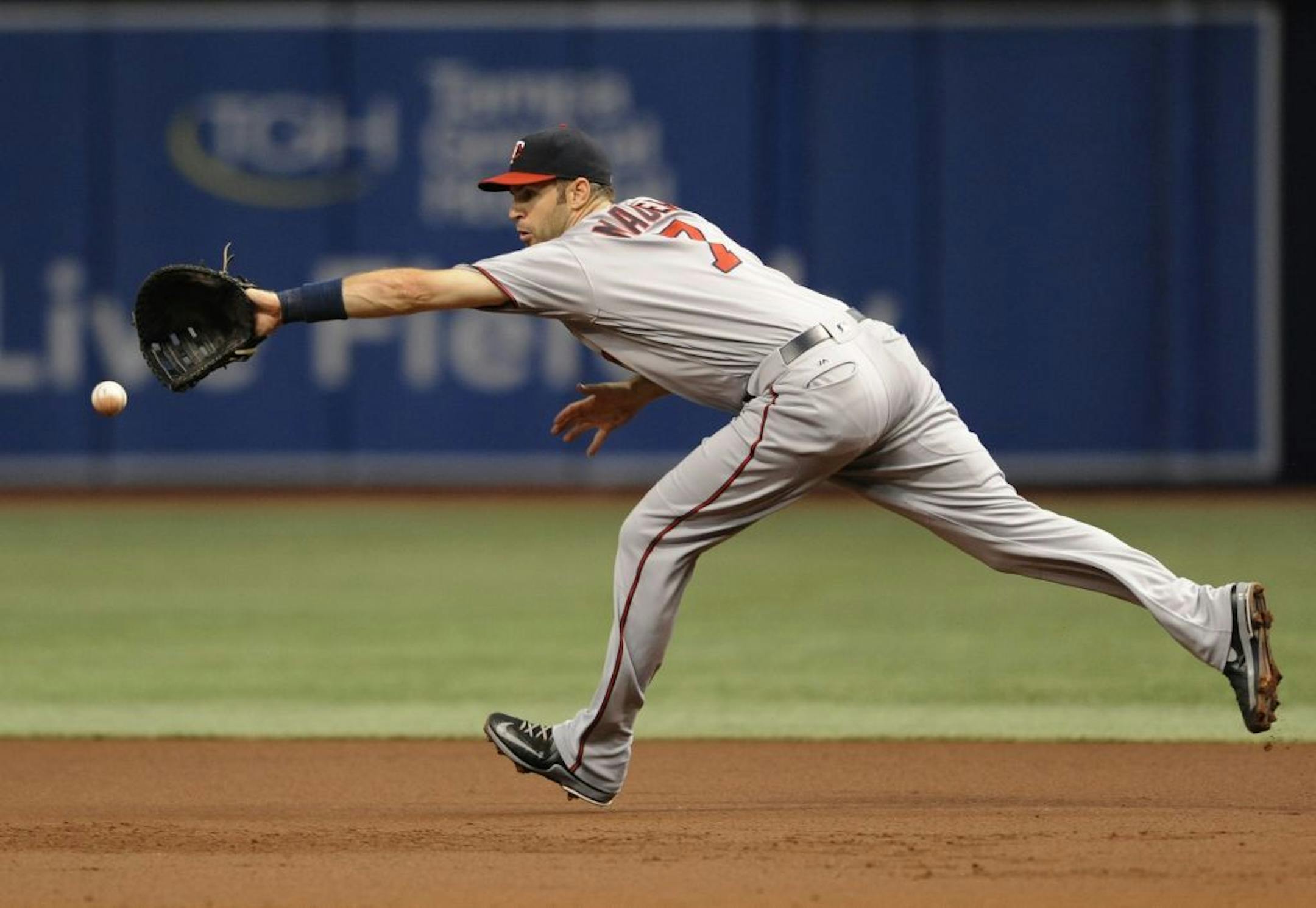 Minnesota Twins first baseman Joe Mauer stretches for a RBI-single by Tampa Bay Rays' Brad Miller during the first inning of a baseball game Saturday, Aug. 6, 2016, in St. Petersburg, Fla.