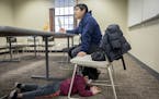 Federico Cano listened to his teacher as his son Yeray, 4, kept busy on his father's smart phone during an ESL class at the University of Minnesota, M
