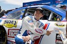 AJ Allmendinger posed by his car after winning the pole position qualifying for the NASCAR Sprint Cup Series race on Saturday in Sonoma, Calif.