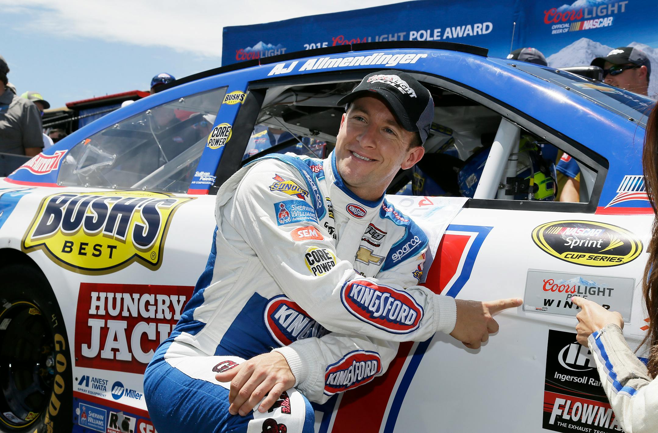 AJ Allmendinger posed by his car after winning the pole position qualifying for the NASCAR Sprint Cup Series race on Saturday in Sonoma, Calif.